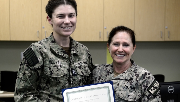 U.S. Navy Capt. Elizabeth Adriano, Navy Medicine Readiness and Training Command's Commander, right, presented Lt. Victoria Medved, left, with a Junior Officer of the Quarter, 4th Quarter, FY2023 certificate during an award presentation at NMRTC San Diego, March 12, 2024. (Photo By Petty Officer 2nd Class Celia Martin) 