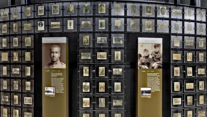 Image of Wall in the museum with pictures and interactive displays. Click to open a larger version of the image.