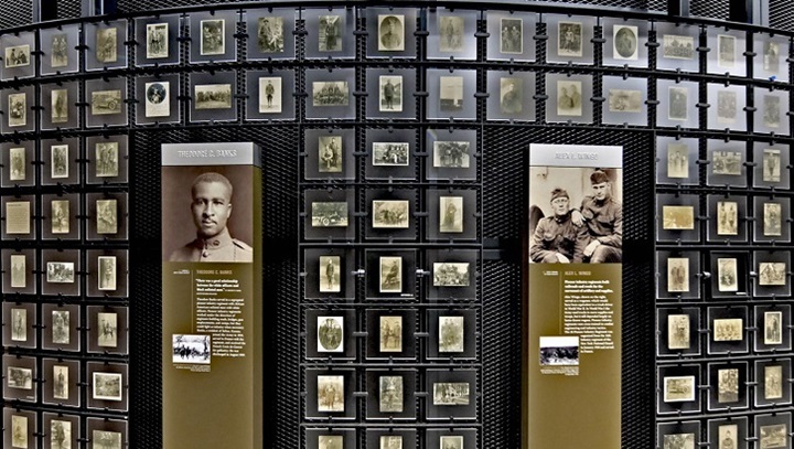 Image of Wall in the museum with pictures and interactive displays.