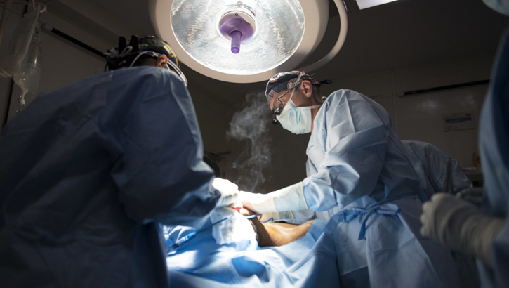 Image of surgeons working on a patient. Click to open a larger version of the image.