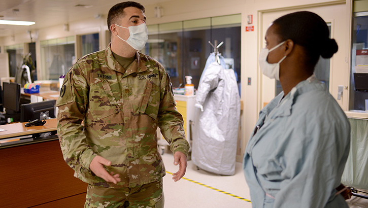 Image of two military nurses talking in a hospital hallway