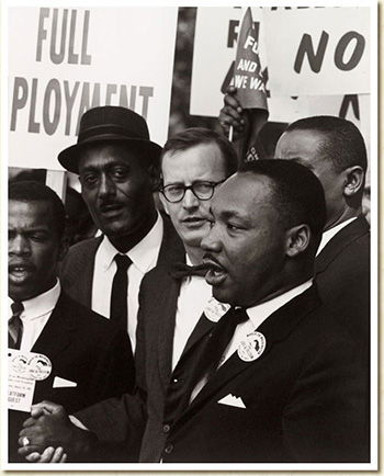 MLK in a crowd with people holding signs