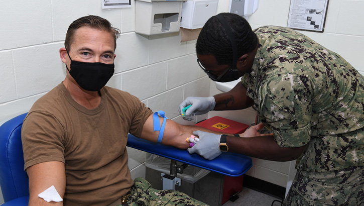 Image of Navy Capt. R. Wade Blizzard, commanding officer of U.S. Navy Support Facility Diego Garcia, donates blood for the Navy Medicine Readiness and Training Units Diego Garcia walking blood bank on Dec. 17, 2020. The walking blood bank is a list of eligible donors who can provide blood in case of emergency. (U.S. Navy photo by Navy Seaman Apprentice Stevin Atkins).