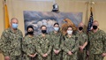 Military personnel wearing face mask posing for a picture