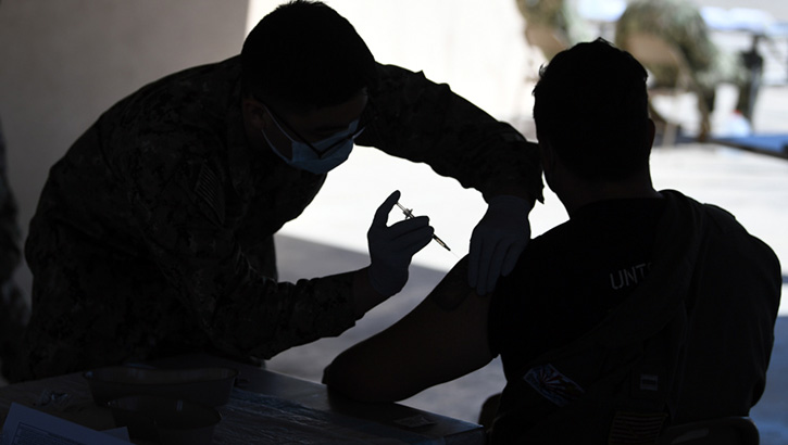 Military health personnel administering the COVID-19 vaccine