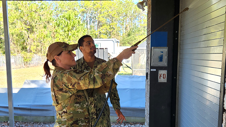 U.S. Air Force Capt. Deanna Scheff (left) receiving pesticide application training from U.S. Air Force Ensign Benfry DeJesus (right) during the largest inter-agency pesticide certification course delivered in nearly five years on Naval Air Station Jacksonville. (Photo by U.S. Navy Lt. Nicholas Johnston)