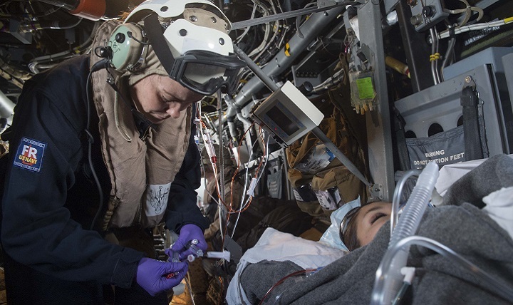 Navy Lt. Kathleen Kostka (left), from Virginia Beach, Virginia, a critical care nurse embarked aboard USS Kearsarge attached to Fleet Surgical Team 4, simulates sedating a patient during a medical evacuation drill in an MV-22 Osprey. 