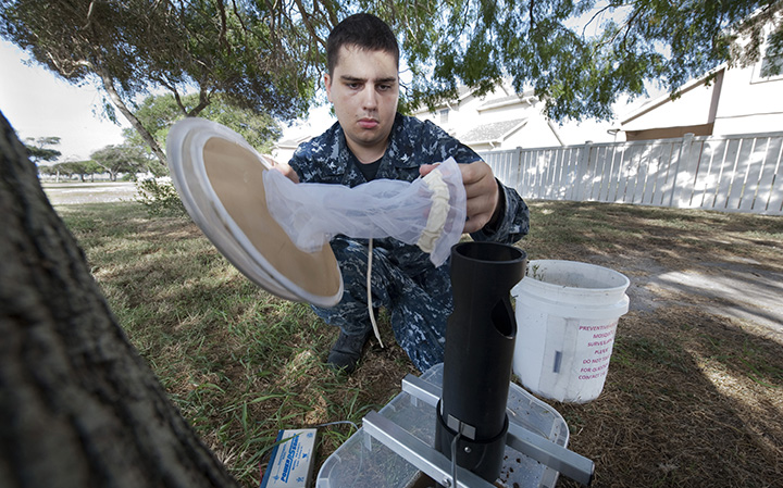 Hospital Corpsman 3rd Class Taylor Boynton, a preventive medicine representative, assembles mosquito traps. 