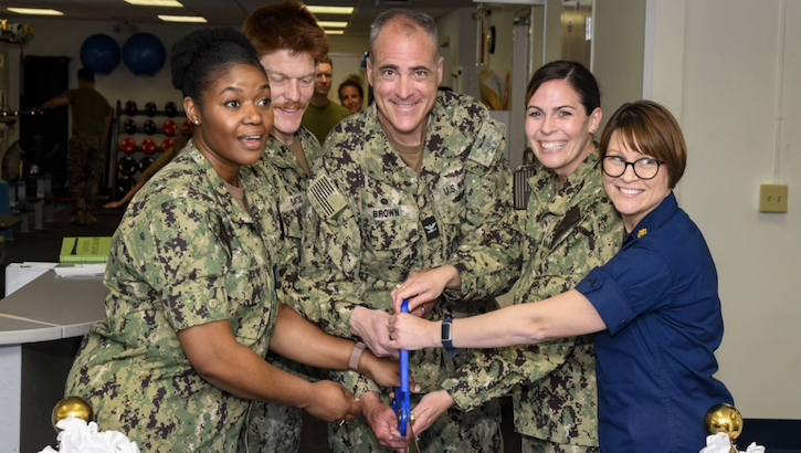 Military personnel celebrate ribbon cutting of new physical therapy space