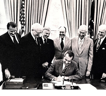 Image of a group of men around President Richard Nixon.