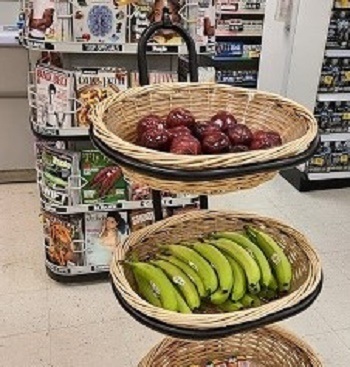 Two baskets full of  fresh apples and bananas 
