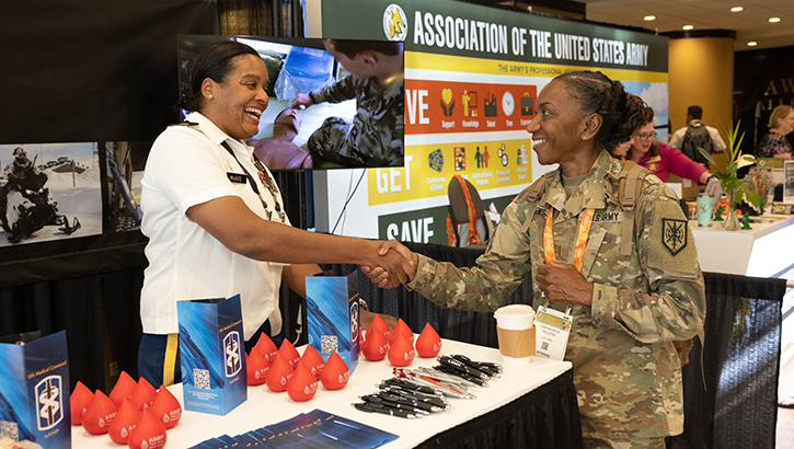 U.S. Army Maj. Nekkeya McGee, a clinical operations blood operations consultant with the 18th Medical Command, discusses medical logistics with a Land Forces Pacific Symposium and Exposition 2023 attendee in Honolulu, Hawaii, on May 16, 2023. (Photo by U.S. Army Sgt. 1st Class Timothy Hughes)