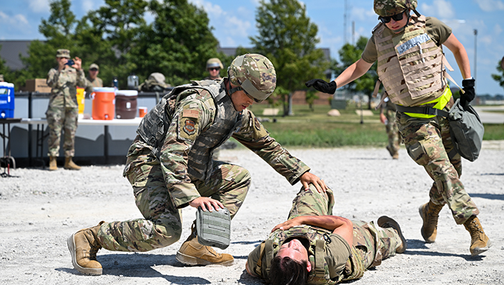 U.S. Air Force Reserve Master Sgt. Brandon Fitch and 1st Lt. Erin Patinella, a medical technician and clinical nurse, respectively, with the 932nd Aeromedical Staging Squadron, rush to a simulated field casualty during Tactical Combat Casualty Care training
