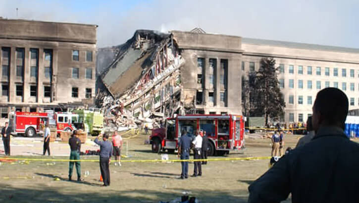Onlooks view the collapsed side of the Pentagon building.