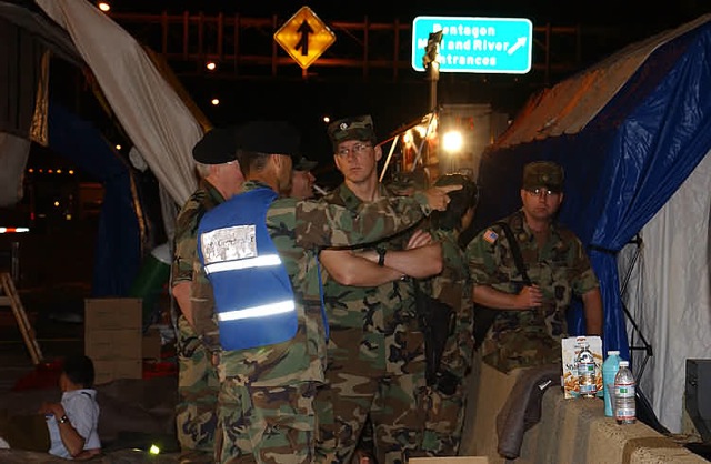Link to Photo: Dr. James Geiling (back to camera, in the blue vest), at the time an Army colonel in charge of the Pentagon's DiLorenzo Tricare Health Clinic, directs the medical response after the terrorist attack on the Pentagon on Sept. 11, 2001.