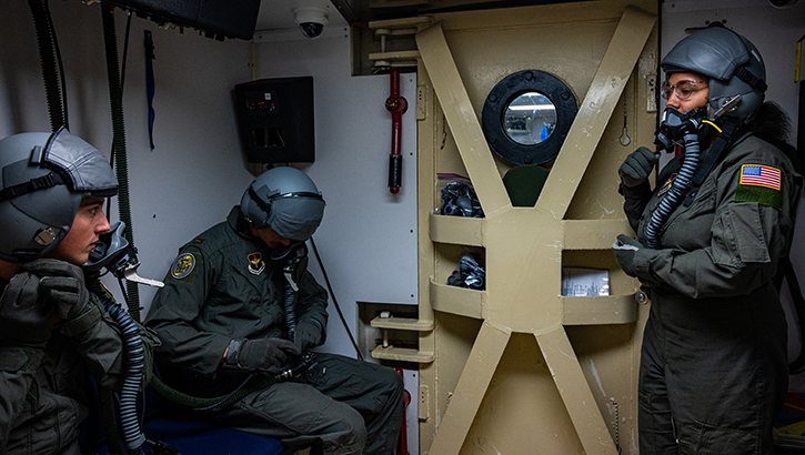 U.S. Air Force Senior Airman Jada Peters instructs students how to correctly use aircraft equipment in the altitude chamber at Laughlin Air Force Base, Texas, on Feb. 24. The altitude chamber is one of the first training steps for all new pilots and aircrew to demonstrate and know the symptoms of hypoxia. (Photo by U.S. Air Force Senior Airman David Phaff)