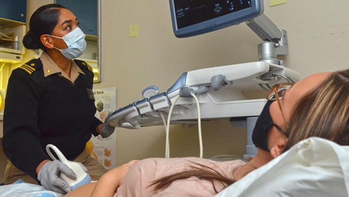 Image of A certified nurse midwife performs an ultrasound on a patient.