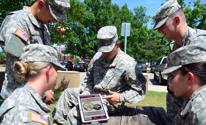 Soldiers, at Lyster Army Health Clinic, utilize the new mobile health app for Fort Rucker, Ala. The app can be used to find useful links and contact information for various places of interest on Fort Rucker, as well as events happening on post. (U.S. Army photo by Jenny Stripling)