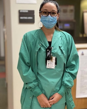 Image of Ms. Connell in hospital dress, wearing a mask