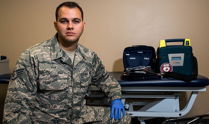 Air Force Staff Sgt. Geoffrey Rigby, 56th Medical Operations Squadron physical therapy technician, poses in front of emergency medical equipment. Rigby helped to save a life using his medical knowledge and training in Glendale, Arizona. (U.S. Air Force photo by Airman 1st Class Alexander Cook)