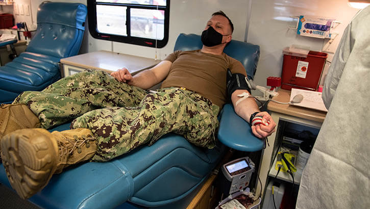 Image of Navy Lieutenant Daniel Murrish, a Sailor serving aboard Naval Health Clinic Cherry Point, donates blood during a blood drive hosted by the Armed Services Blood Program. .