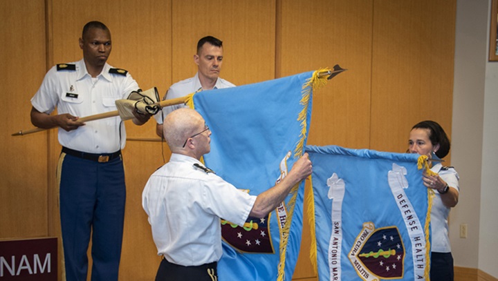 Image of Military personnel unveiling flags.