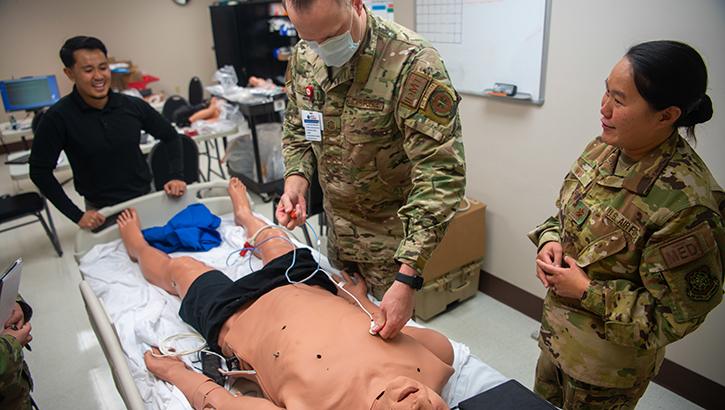 Military medical personnel training on CAE apollo mannequin