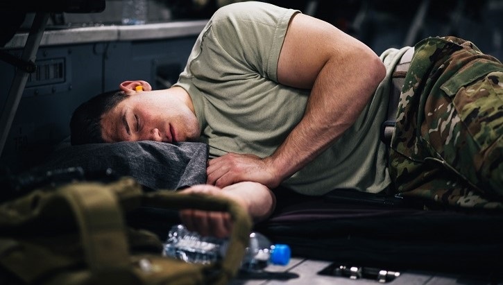 Airman sleeping on floor of plane