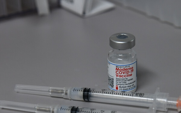 COVID-19 vaccine bottle and syringes