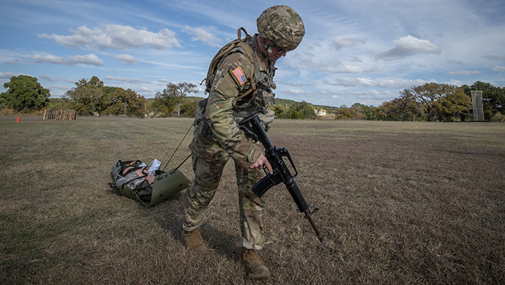 Image of U.S. Army Sgt. Henry Gross, a radiology specialist, drags a simulated patient to safety during Brooke Army Medical Center’s NCO and Soldier of the Year competition at Camp Bullis, Texas, in 2019. The Defense Health Agency’s Virtual Education Center will provide service members with the health and medical information they need to stay ready for the mission.  (U.S. Army photo by Jason W. Edwards).
