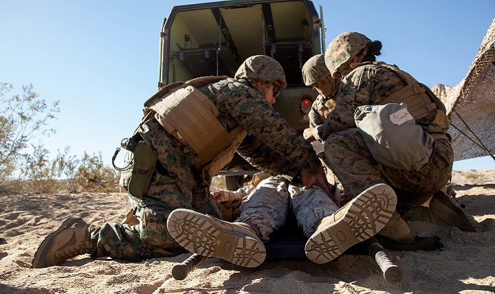Navy corpsmen and Marines check a simulated casualty and remove their body armor during Exercise Steel Night’s mass casualty drill at Marine Corps Air Ground Combat Center Twentynine Palms, Calif., Dec. 12, 2015. 