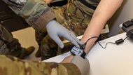 U.S. Army Sgt. Michael Bourguillon, assessor with the Walter Reed Army Institute of Research-West, applies electrodes to U.S. Army Spc. Amanda Pinkston as part of a study on brain health and posttraumatic stress disorder