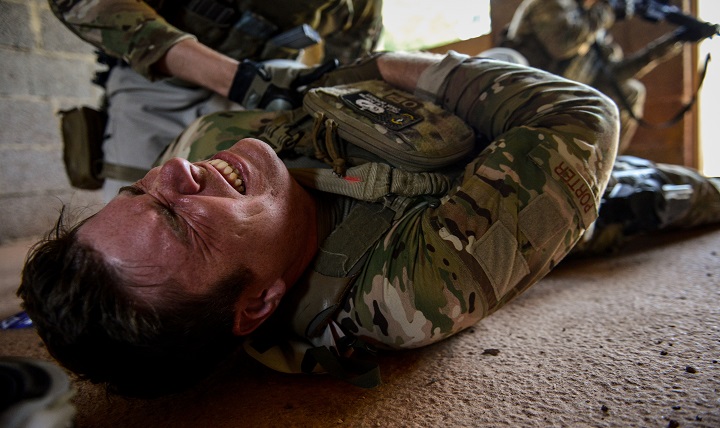 Staff Sgt. Clay Porter, 435th Security Forces Squadron Ground Combat Regional Training Center instructor, is treated for a simulated gunshot wound during the Tactical Combat Casualty Care.