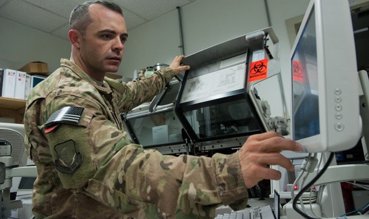 U.S. Air Force Tech. Sgt. Scott Hatch, 455th Expeditionary Medical Group biomedical equipment technician and Craig Joint Theater Hospital facility manager, performs maintenance on a blood testing machine at Bagram Air Field, Afghanistan. (U.S. Air Force photo by Tech. Sgt. Joseph Swafford)
