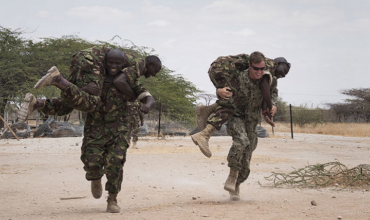 U.S. Navy Petty Officer 3rd Class Nick Mettler, an Explosive Ordnance Disposal technician, races a Kenyan Defense Force combat engineer during a buddy carry lesson for the tactical combat medical training portion of Deliberate Kindle. The medical training was one portion of the course taught by Task Force Sparta, which is currently assigned to Combined Joint Task Force-Horn of Africa. (U.S. Air Force photo by Staff Sgt. Tiffany DeNault)