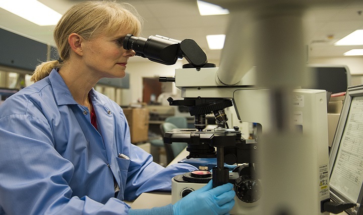 Dolli Lane, 96th Medical Group laboratory technician, reviews a sample through the microscope at Eglin Air Force Base, Florida. 