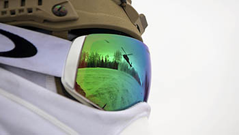Reflection on goggles of snowy scene.