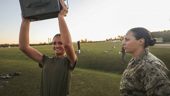 Marine Corps Pfc. Barbara Pujolllopiz, (left), an administrative specialist with the 22nd Marine Expeditionary Unit, performs ammo can lifts while Capt. Katheryn Evazich, the MEU's adjutant, observes and counts repetitions during a Combat Fitness Test aboard Camp Lejeune, North Carolina. The CFT is an annual Marine Corps physical training requirement in the which assesses combat readiness. (U.S. Marine Corps photo by Cpl. Tawanya Norwood)