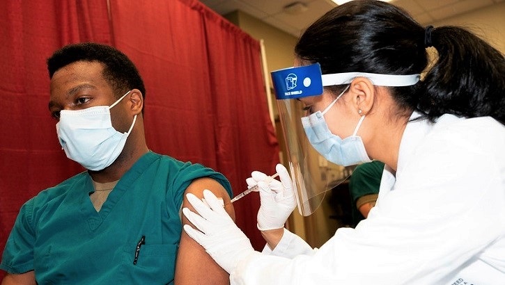 Image of a man getting a vaccine. Click to open a larger version of the image. Click to open a larger version of the image.