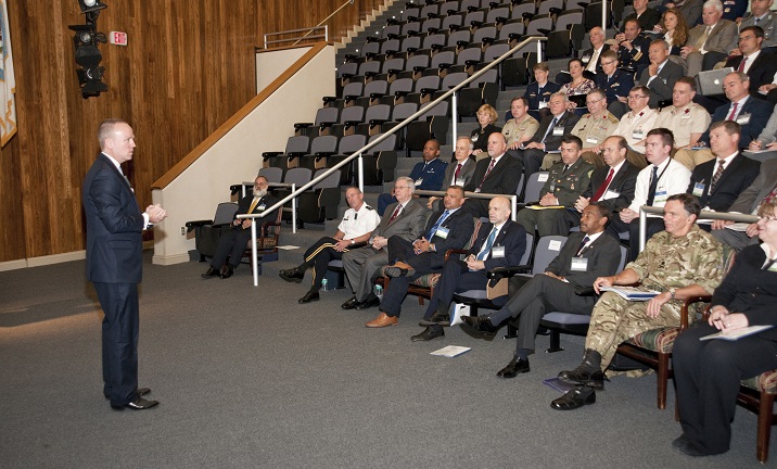 Undersecretary of Defense Brad Carson (left) addresses the attendees at the Warrior Care in the 21st Century symposium at the Uniformed Services University of the Health Sciences in Bethesda, Md. Attendees included senior military and civilian representatives from Australia, Canada, Denmark, Estonia, France, Georgia, Germany, New Zealand, the Netherlands and the United Kingdom for focused discussions on the topics of readiness, recovery and rehabilitation, and reintegration and post-military support. (Courtesy photo)