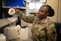Airman 1st Class Wisdom Edem, 55th Medical Support Squadron pharmacy technician, pours pills into a pill counter