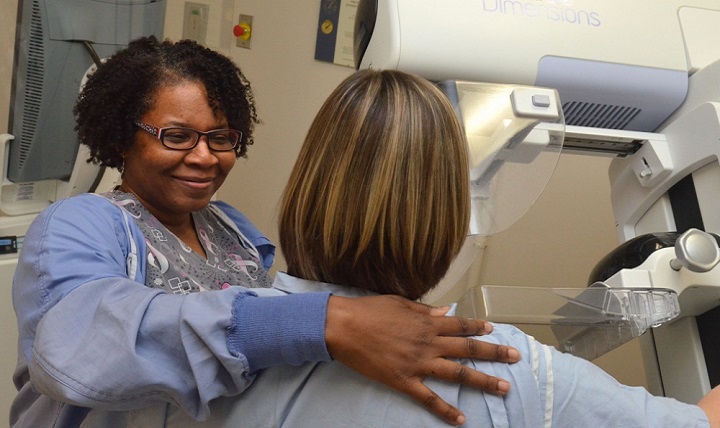 Tracy Stephens, a radiologic technologist at Naval Hospital Jacksonville, prepares a patient for a mammogram. Mammograms are the best way to find breast cancer early, when it’s easier to treat and before it’s big enough to feel. (U.S. Navy photo by Jacob Sippel)