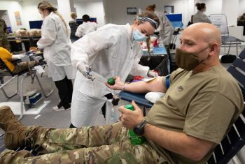 Military personnel donating blood