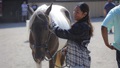 Horse on left with ARNG Spc. Yesenia Flores, at an equine therapy program used by Fort Campbell's Soldier Recovery Unit.