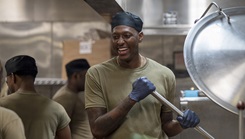 Air Force Senior Airman James Cawley, 94th Force Support Squadron food services technician, smiles while stirring food