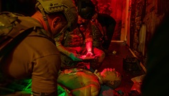 U.S. airmen assigned to Air Force Special Operations Command stabilize a casualty and document patient care during a tactical field care exercise