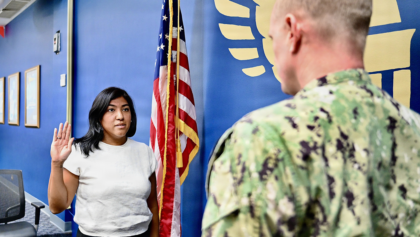 Lt. Cmdr. Robert Johnson, Medical Officer Programs and Scholarships officer assigned to Navy Talent Acquisition Group Great Lakes, administers the commissioning oath to Ensign Carina Alers
