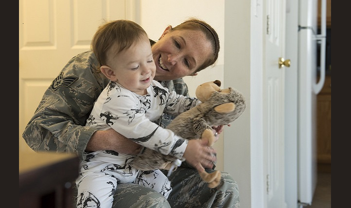 Air Force Staff Sgt. Charity Lee Vest, 87th Aerospace Medicine Squadron operational medicine technician, holds baby Arlo at his home on Joint Base McGuire-Dix-Lakehurst, New Jersey. Vest received a knock on the door from a neighbor who exclaimed their 14 month-old son was unresponsive and needed medical attention. Vest used her CPR training to resuscitate the infant. (U.S. Air Force photo by Airman 1st Class Jessica Blair)