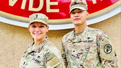 Two soldiers standing in front of the Bayne-Jones Army Community Hospital