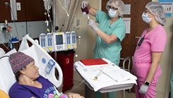 Audrey Hawes, registered nurse, and Josephine Valdez, registered nurse, administer stem cells during patient Roniesha Blaylock’s procedure at Brooke Army Medical Center, Joint Base San Antonio 